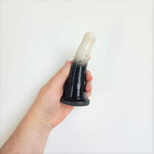 Load image into Gallery viewer, A hand holds a 5 inch curved ceramic dildo in a white and black gradient pattern in front of a white background