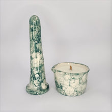 Load image into Gallery viewer, A 6 inch classic ceramic dildo and a matching massage candle in a dark green bubble pattern stand in a white photo booth.