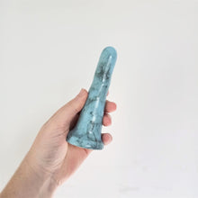 Load image into Gallery viewer, A hand holds a 5 inch classic ceramic dildo in light blue with a black bubble pattern in front of a white background.